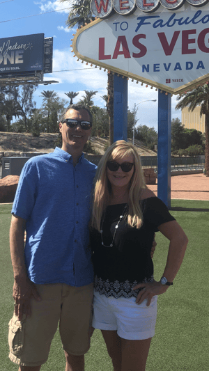 Al Mielnik and his wife in front of welcome to las vegas sign