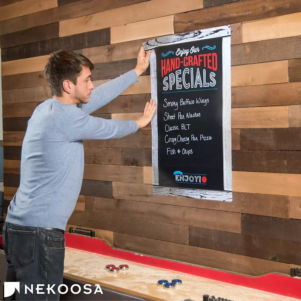 Man hanging a chalkboard menu made from ChalkTalk chalkboard vinyl.